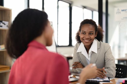 Two young colleague business woman discussing ideas using a laptop computer. business financial concept
