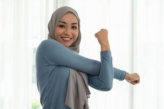 Portrait beautiful young muslim asian woman doing exercise at home. Healthy lifestyle and good wellness concepts