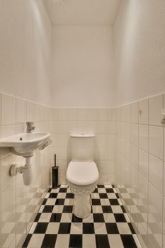 Flush toilet and shower cabin with tile partition and curtain located near sink and mirror in washroom at home