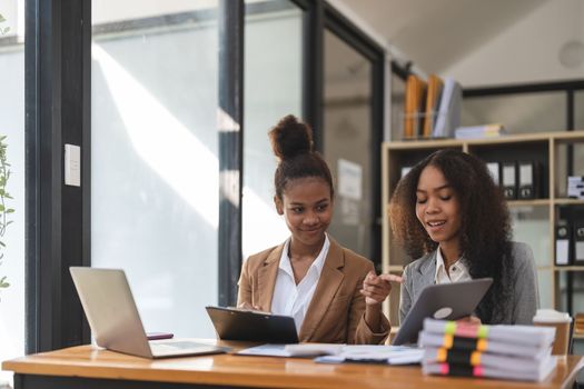 Two young business people working together in office. financial analysis accounting concept