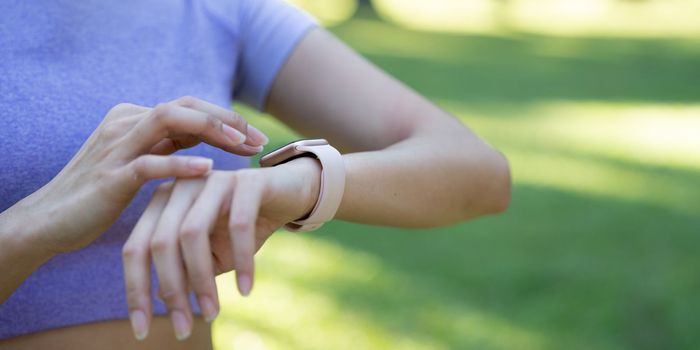 Close up of hand touching smartwatch with health app on the screen, gadget for fitness active lifestyle. running training outdoors