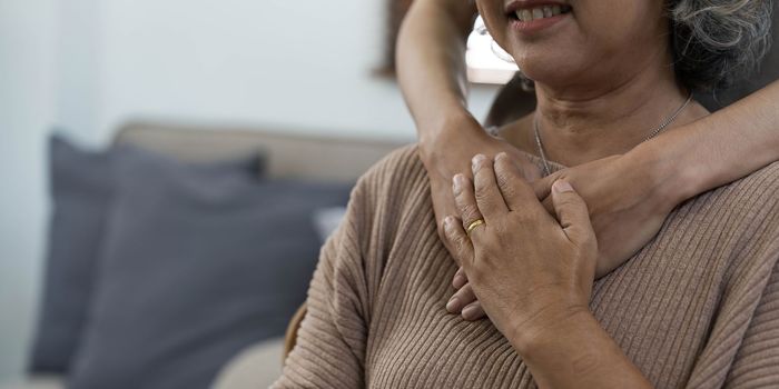 A young woman, a volunteer, carefully hugs his beloved grandmother, supports and helps an elderly woman in retirement, his grandparent. Young female and female elderly hands with wrinkles closeup.