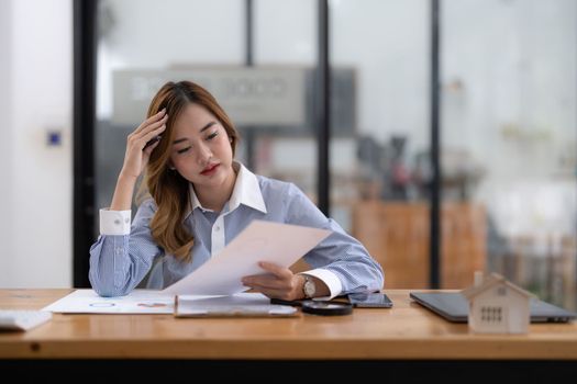 Asian investor businesswoman getting stressed about real estate finance