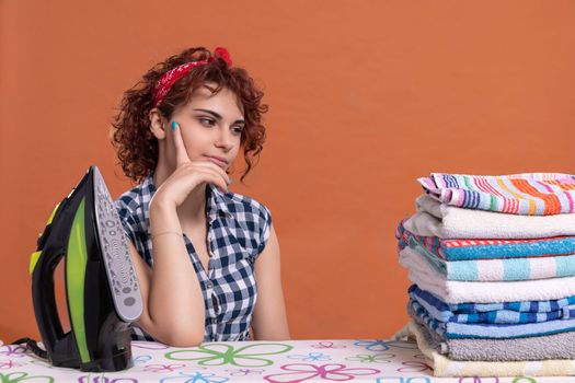 A girl glances at the ironed towels. A woman with big beautiful eyes. It's time to relax after doing the daily work at home.