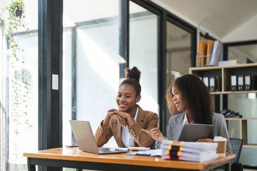 Two young business people working together in office. financial analysis accounting concept