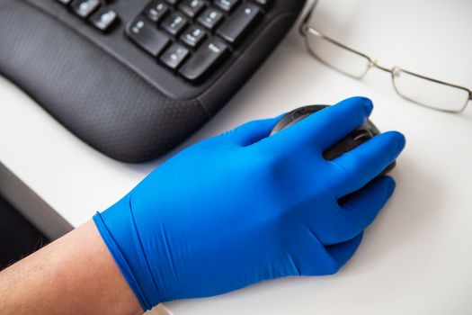 A doctor in blue gloves quickly collects data about a patient. The concept of healthcare and taking care of your health. Workplace of a doctor, online consultation