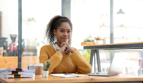 Portrait of Young woman using laptop computer at the office, Student girl working at home. Work or study from home, Asian woman freelance, business, lifestyle concept.