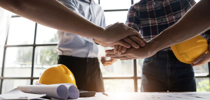 Team of engineer and architects working join hands to build successful projects. Teamwork concept