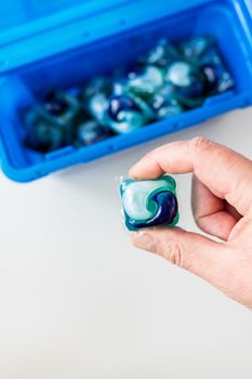 Holding washing powders in multi-colored capsules. The concept of washing and cleanliness