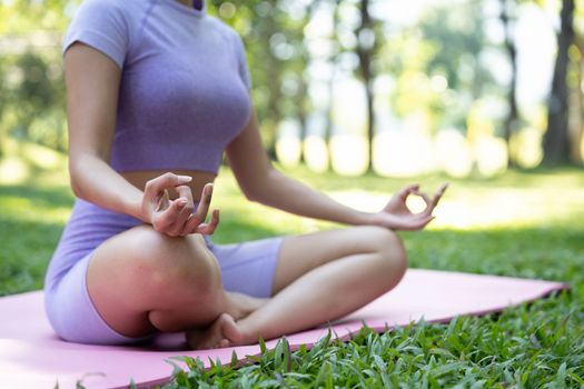 Close up hands. Woman do yoga relax outdoor. Woman exercising pose vital and meditation for fitness lifestyle club at the outdoors nature background. Healthy and Yoga Concept