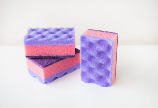 A group of multi-colored kitchen sponges. Set of colorful sponges for the kitchen. Cleaning and cleaning concept