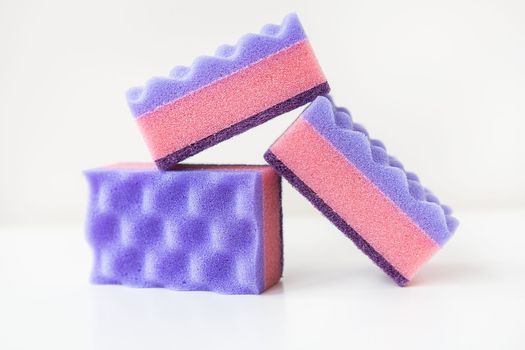 A group of multi-colored kitchen sponges. Set of colorful sponges for the kitchen. Cleaning and cleaning concept