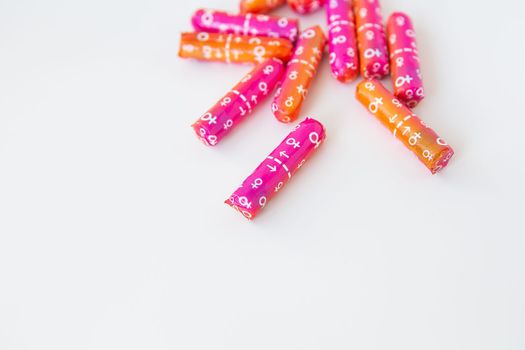 Tampons in pink and orange packaging. Hygiene and health concept. Place for an inscription