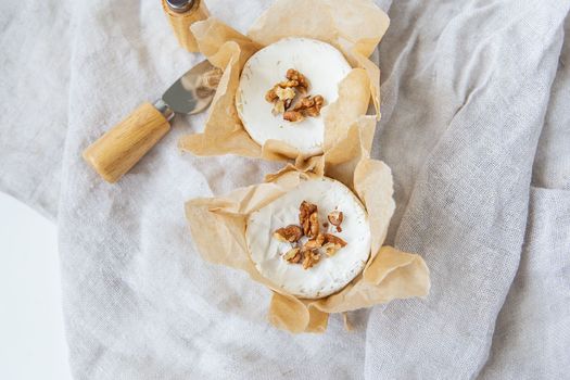 Baked Camembert with walnuts and honey wrapped in parchment, delicious and healthy food