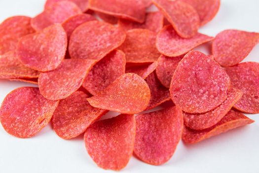 Red chips with hot pepper taste on a white background. Beer snack