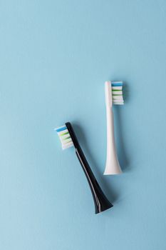 Modern electric toothbrush on a blue background. Hygiene concept for daily oral care