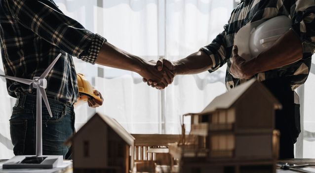 Hand in hand between project contractors and customers due to negotiation of expenses and investments, construction and repair of residential buildings..