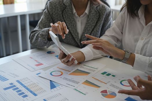 Asian business adviser meeting to analyze and discuss the situation on the financial report in the meeting room.Investment Consultant,Financial Consultant,Financial advisor and accounting concept.