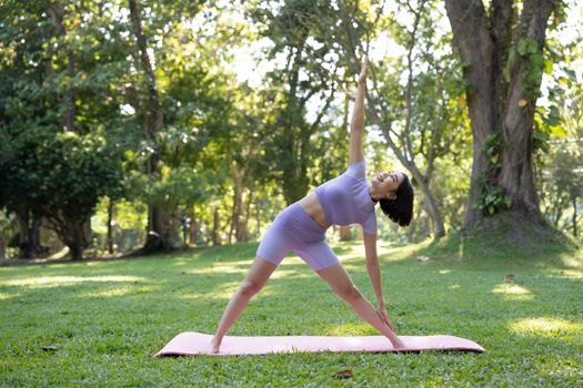 Portrait of happiness young woman practicing yoga on outdoors.Yoga and relax concept. Beautiful girl practice asana.