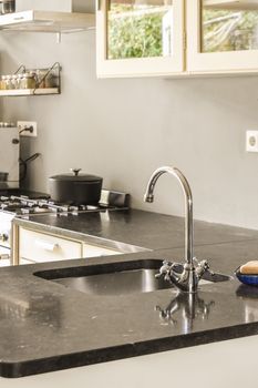 a kitchen that is very clean and ready to be used for cleaning the counters, sink, stove or dishwasher