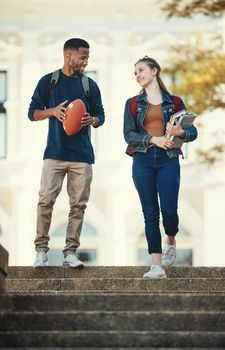 Friends, education and walking with diversity students on college or university campus together. Study, school and books with a man and woman pupil talking or bonding during their walk to class.