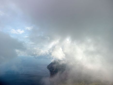 Blue sky with white clouds over calm summer panorama of the sea. Drone aerial view. Abstract aerial nature summer ocean sunset sea and sky background. Horizon. No people. Holiday and vacation concept