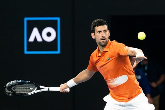 MELBOURNE, AUSTRALIA - JANUARY 13: Novak Djokovic of Serbia hits a shot to Nick Kyrgios of Australia in an Arena Showdown charity match ahead of the 2023 Australian Open at Melbourne Park on January 13, 2023 in Melbourne, Australia.