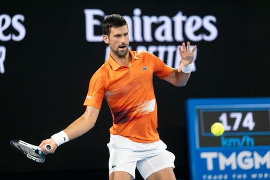 MELBOURNE, AUSTRALIA - JANUARY 13: Novak Djokovic of Serbia hits a shot to Nick Kyrgios of Australia in an Arena Showdown charity match ahead of the 2023 Australian Open at Melbourne Park on January 13, 2023 in Melbourne, Australia.