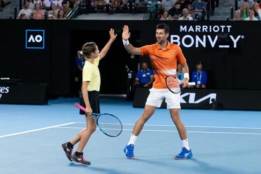 MELBOURNE, AUSTRALIA - JANUARY 13: Novak Djokovic and Ana Maric celebrate a point against Nick Kyrgios and Thaadhie Karunanayake in an Arena Showdown charity match ahead of the 2023 Australian Open at Melbourne Park on January 13, 2023 in Melbourne, Australia.