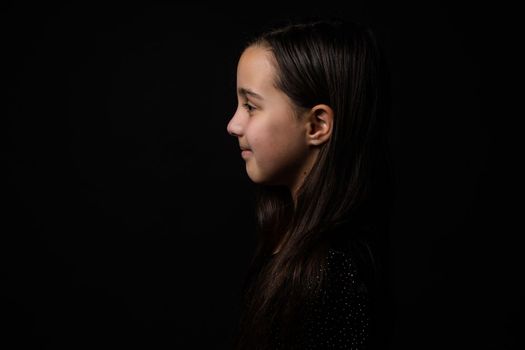 portrait of a child close-up, little girl on a black background.