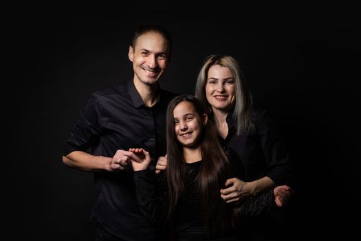 Family portrait on black background.