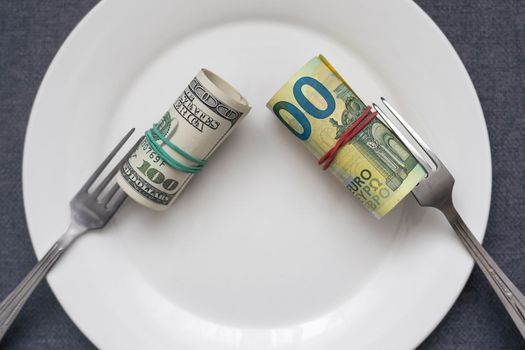 One american dollar bill on a white empty plate with utensils. On white background