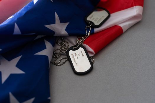 military forces, military service, patriotism and nationalism concept - close up of american flag and soldiers badges