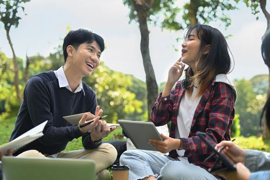 Group of students or teenagers with tablet doing homework at campus. Youth lifestyle and education concept.