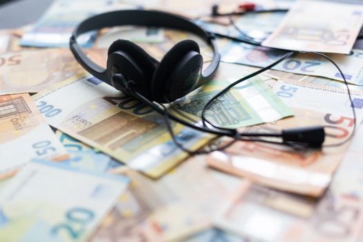 euro banknotes headphones headset. Money and technology still life concept