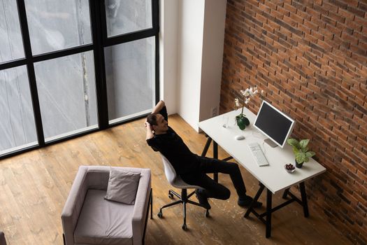 Young business man working at home with laptop on desk.