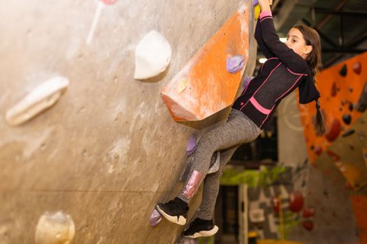 Youngster's effort in climbing a wall to reach the top