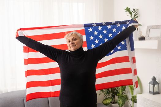 Charming mature woman in USA flag celebrating 4th of july. United States independency day