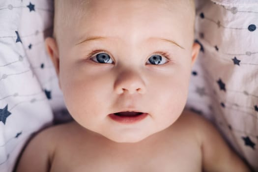 Close-up of the face of a cute baby lying in.