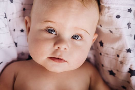 Close-up of the face of a cute baby lying in.