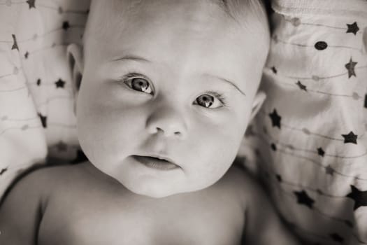 Close-up of the face of a cute baby lying in.
