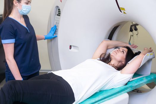 Doctor doing computed tomography for female patient stock photo. Medicine diagnostic concept.