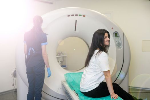 Doctor doing computed tomography for female patient stock photo. Medicine diagnostic concept.