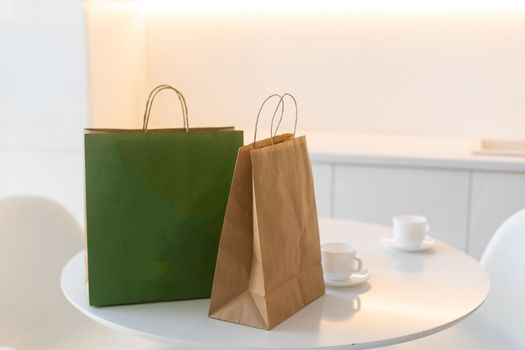 Eco shopping paper bag on the table in modern kitchen. Food delivery or market shopping concept.