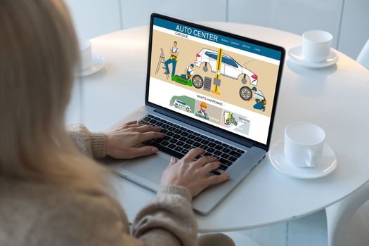woman with laptop with auto center app. Car service business concept and smart checklist of car service on virtual screen.