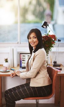 Technology lets me work anywhere. Portrait of a woman working at her laptop in a home office