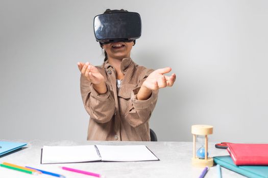 Little girl using VR glasses at home for learning. Modern education science concept.