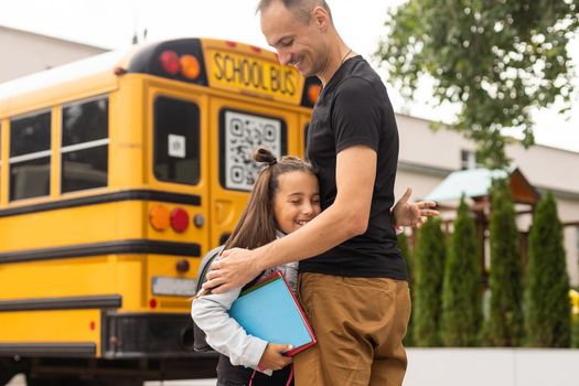 Parent taking child to school. Pupil of primary school go study with backpack outdoors. Father and son go hand in hand. Beginning of lessons. Back to school. First day of fall. Elementary student.