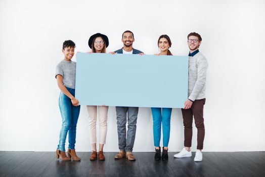 If its important to you, its important to us. Studio shot of a group of young people holding a blank placard against a white background