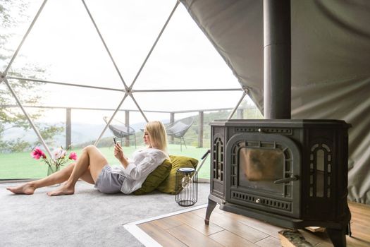 woman with tablet in dome tent.